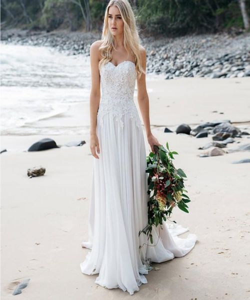 

strapless fitted waist wedding gown with soft flowing chiffon skirt with train delicate lace and pearl detailing beach bridal dres3331073, White