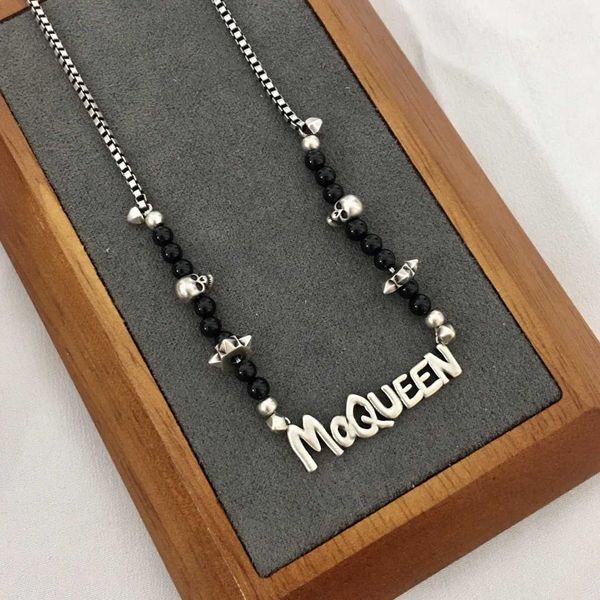 

fashion designer alexander queen black agate skull head letter necklace for women with advanced sense and personalized temperament brass col
