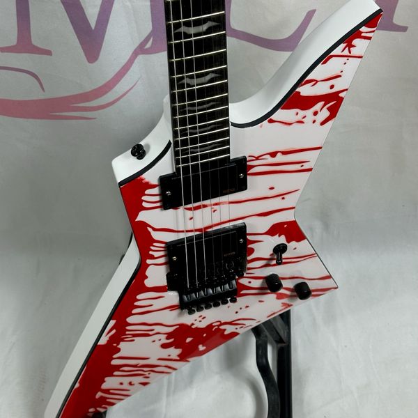 

white unusual shaped electric guitar with blood pattern rosewood fingerboard