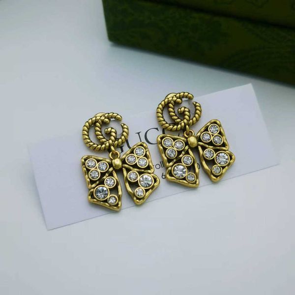 

fashion collection 2023 new luxury fashion jewelry for light luxury classic old diamond inlaid bow ancient family design double earrings, Golden