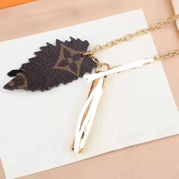

2023 designer new donkey family old flower skin feather leaf gold whistle necklace versatile couple sweater chain, Black