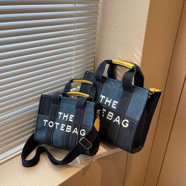 

2023 fashion hand new women's large capacity color contrast splicing denim portable commuter tote bag
