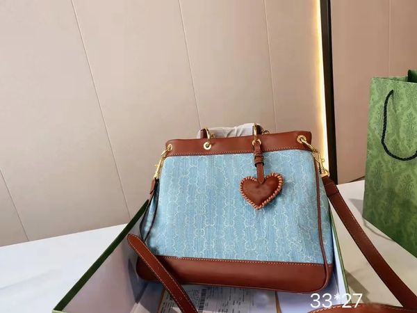

designer designed women's shoulder bag. blue denim with brown leather, fashionable and versatile. size: 33 * 27cm., Black;red
