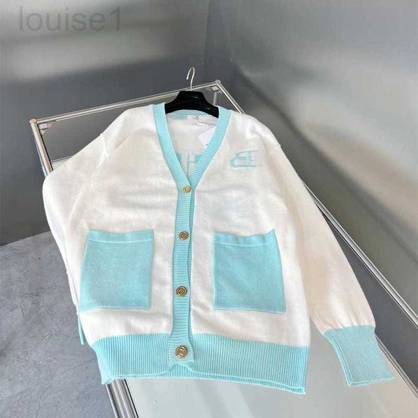 

women's knits & tees designer autumn and winter paris color matching peacock blue double pocket fresh college style women's knitte, White