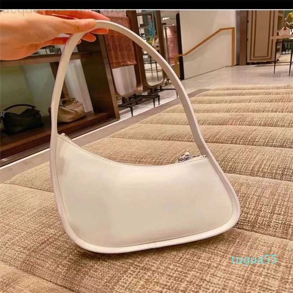 

the row half moon bag in smooth leather women designer with flat shoulder strap and curved zipper