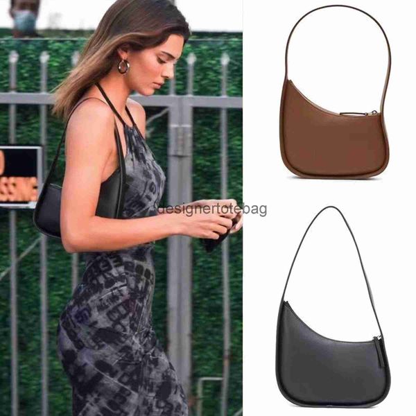 

the row half moon bag in smooth leather women designer with flat shoulder strap and curved zipper closure tote suded lining underarm