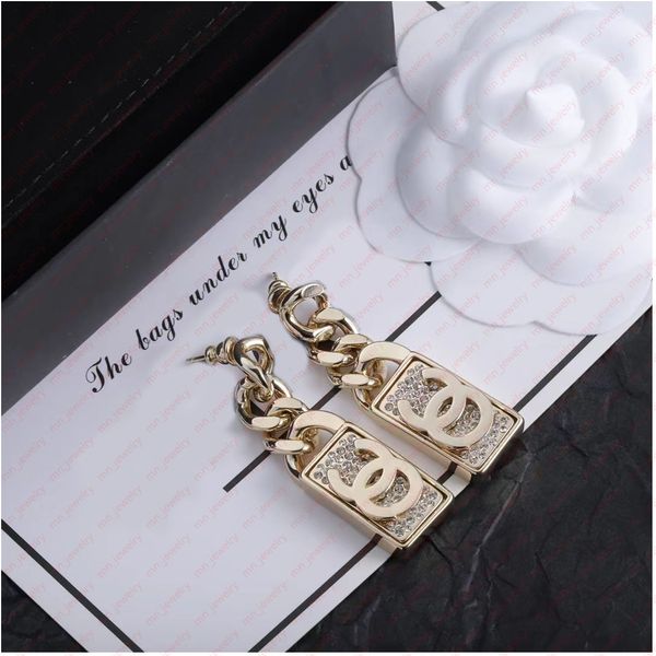 

golden brass stereo nameplate bride luxury earrings. classic designer earrings for women. pretty designer jewelry.
