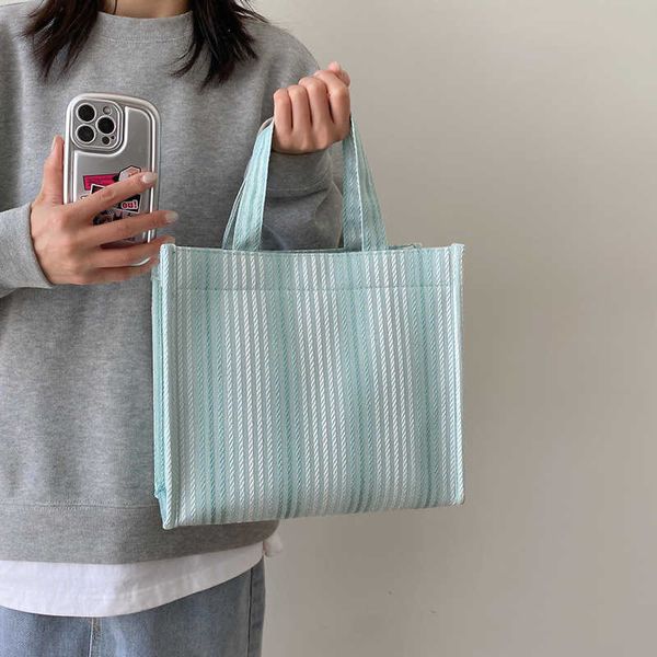 

large capacity handheld tote women's bag new foreign handheld student makeup bag casual stripe canvas shoulder bag fashion bag