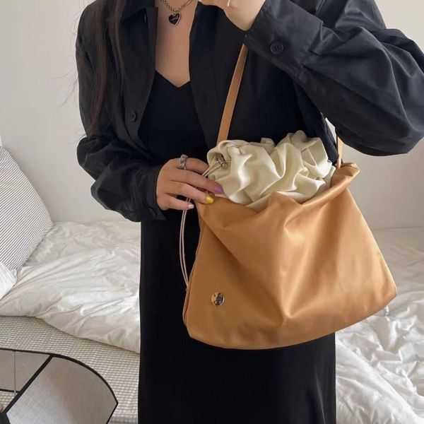 

the row nylon cloud bag is a lightweight and lazy style one shoulder crossbody bag with a large bag that is popular on the internet. the sam