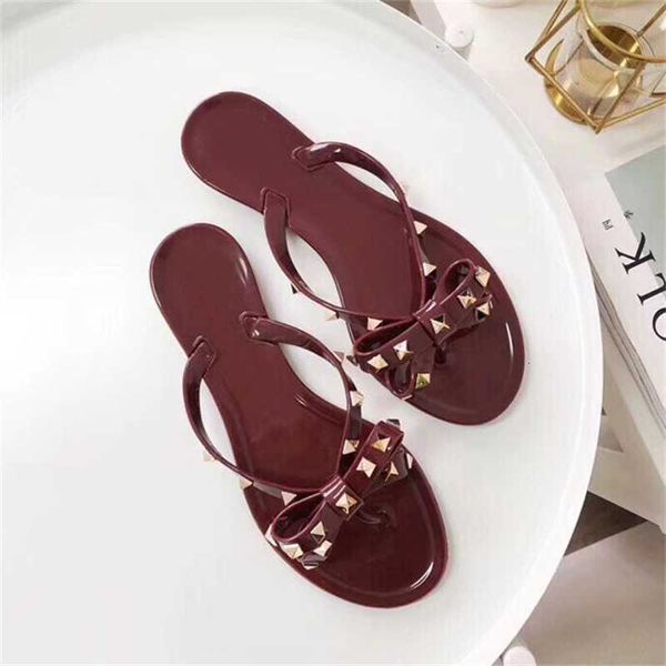 

2023 summer new rivet bow flat bottom herringbone slippers women's pvc leisure clip toe wear beach sandals, Black