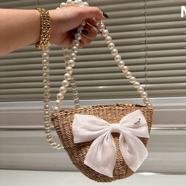 

summer straw pearl chain bucket bag with large bowknot diamonds metal hardware beach woven handbag crossbody shoulder tote travel drawstring