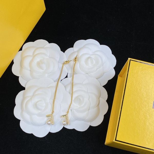 

shiny diamond hoop earrings, luxurious and minimalist earrings, crystal earrings, gold and silver earrings, interlocking letter earring slee, Golden;silver