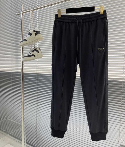 

Pants Men's Autumn and winter style P family preure rubber strip men's ankle guard pants with triangular button woven belt Pra letter casual TLON, Black