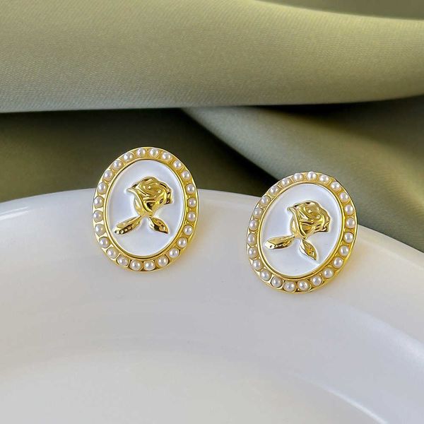 

a niche design with white circular resembling pearls, tulips, and versatile daily commuting ladies earrings kids women charms, Silver