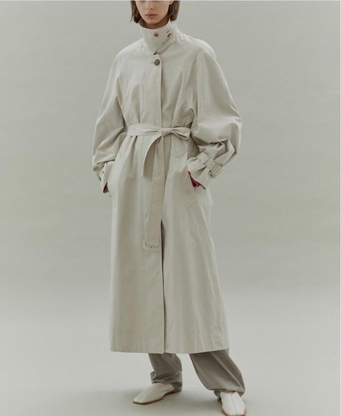 

low class * commuter loose fitting silhouette, medium length, cream white, green 2-color trench coat, female small figure over knee, autumn, Black