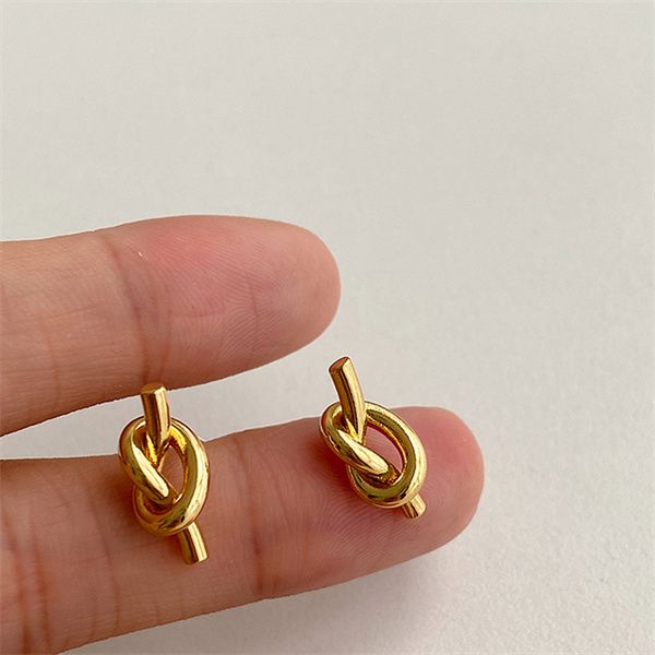 

european and american french light luxury charm fashion temperament cold wind small knotted earrings titanium steel gold-plated female chris, Golden