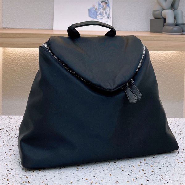 

re-nylon medium backpack saffiano details adjustable woven nylon straps handle zipper pouch enameled metal triangle logo drawstring closure