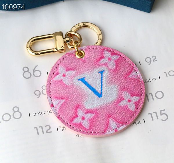 

pink round gold keychain with blue lettering is a fun hanging accessory, Silver