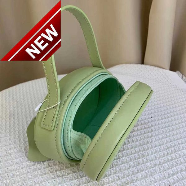 

women's designer bags 2023 spring triumphal arch moon cake pig nose mini round leather hand lipstick factory direct sales