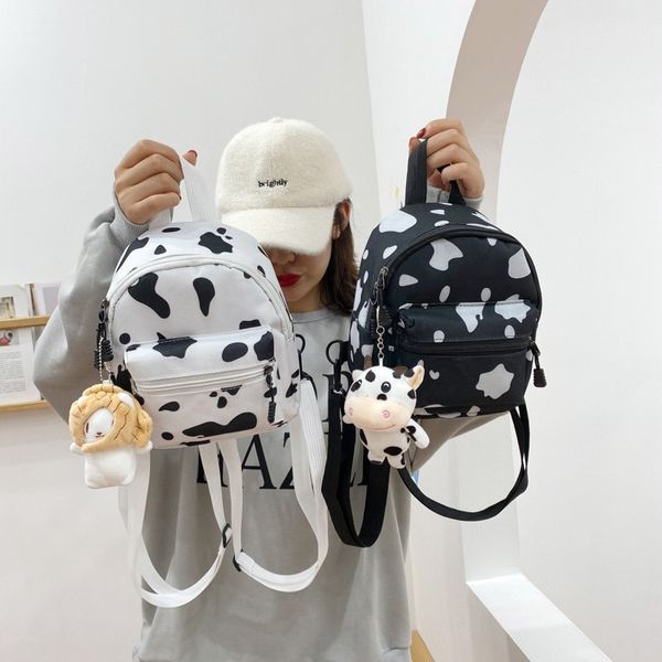 

mini canvas daypack cow print backpack with plush pendant for women lady girls outdoor travel shopping shoulder bag bookbag