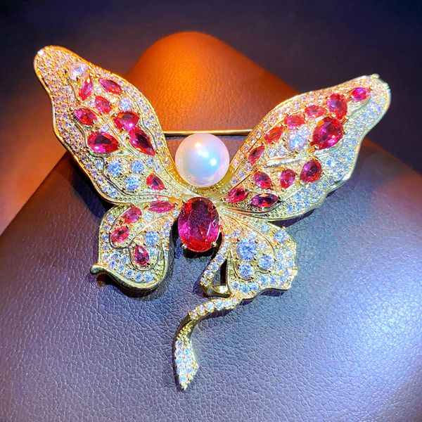 

Designer Heavy duty Butterfly Shaped Brooch with Large Carat Red Zircon and Pearl Inlay, Light Luxury, Fashionable, High end and Premium Brooch