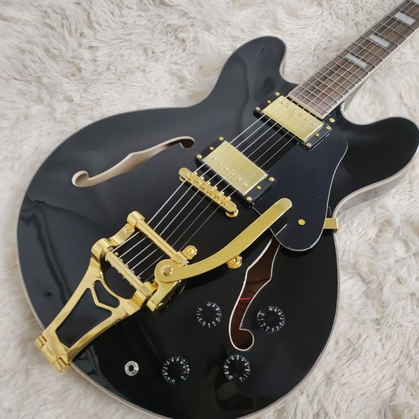

Sleek Glossy Black Semi-Hollow Guitar: Gold Hardware, F-Hole Cutouts & Control Knobs