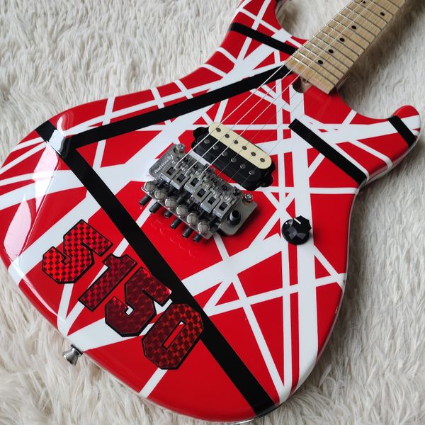 

Vibrant Red Electric Guitar: Bold Black/White Geometric Patterns, Tremolo Bridge & Maple Neck