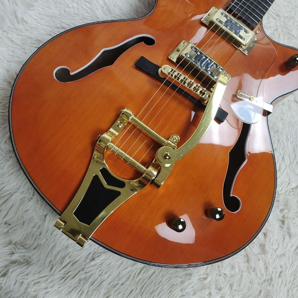 

Warm Glossy Orange Semi-Hollow Guitar: Gold Hardware, F-Holes & Vibrato Bridge