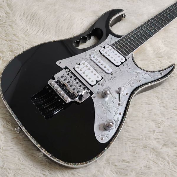 

Sleek Glossy Black Electric Guitar: Silver Floral Pickguard, 3 White Pickups & Metallic Tremolo