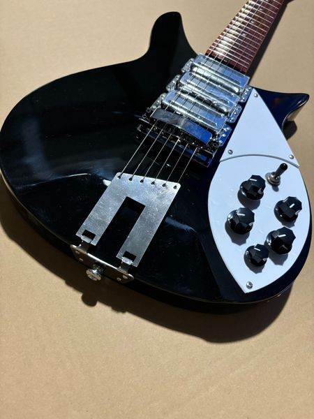 

Sleek Glossy Black Electric Guitar: Silver Pickguard, 3 Metallic Pickups & 5 Control Knobs
