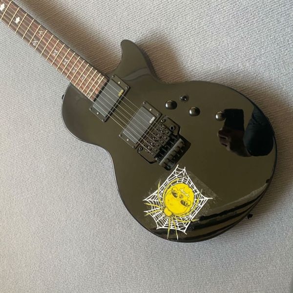 

Sleek Black Electric Guitar with Yellow Skull & White Spider Web Graphic, Black Pickups