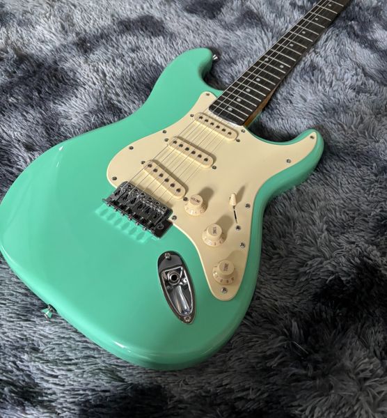 

Vibrant Glossy Turquoise Solid-Body Guitar: Cream Pickguard, 3 Single-Coils & Tremolo Bridge