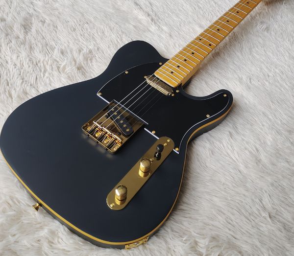 

Sleek Glossy Black Solid-Body Guitar: Gold Trim, Tremolo Bridge & Gold Hardware