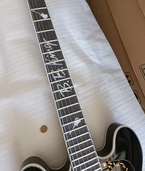 

Sleek High-Gloss Black Single-Cut Electric: Gold Hardware, Intricate Gold Patterns, Signature Accent