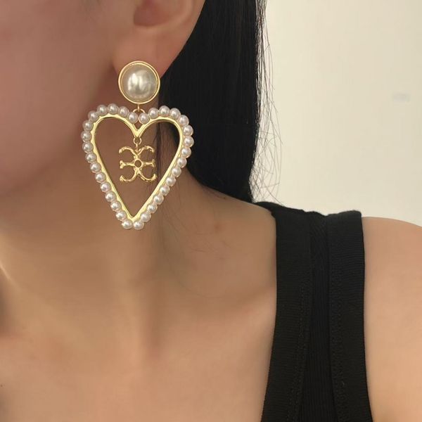 

French vintage pearl heart-shaped earrings - a unique and exclusive design for women, featuring a delicate and luxurious touch, with a fashionable and stylish look.