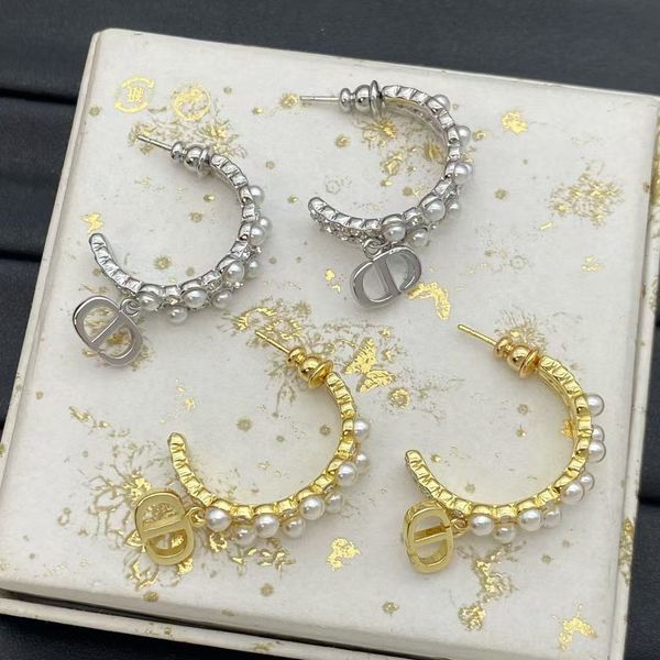 

Letter pendant earrings - two styles of pearl-studded earrings. Fashionable and sophisticated. Round shape. Golden color.