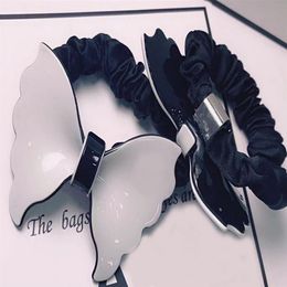 7X5 CM zwart en wit acryl boog elastiekjes C hoofd touw haar ring haarspelden voor dames favoriete hoofdtooi Sieraden Accessoires vi3072