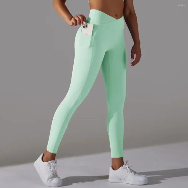 Pantalones activos Levantamiento de cadera Leggings deportivos Mujeres Sólido Desnudo Cruz Cintura Bolsillo Yoga Alto Elástico Fitness Crop Medias