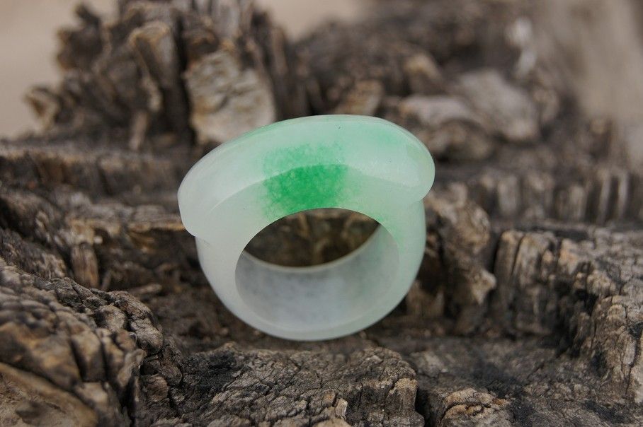 

Handmade natural white float green jade ring. The surface of the saddle ring