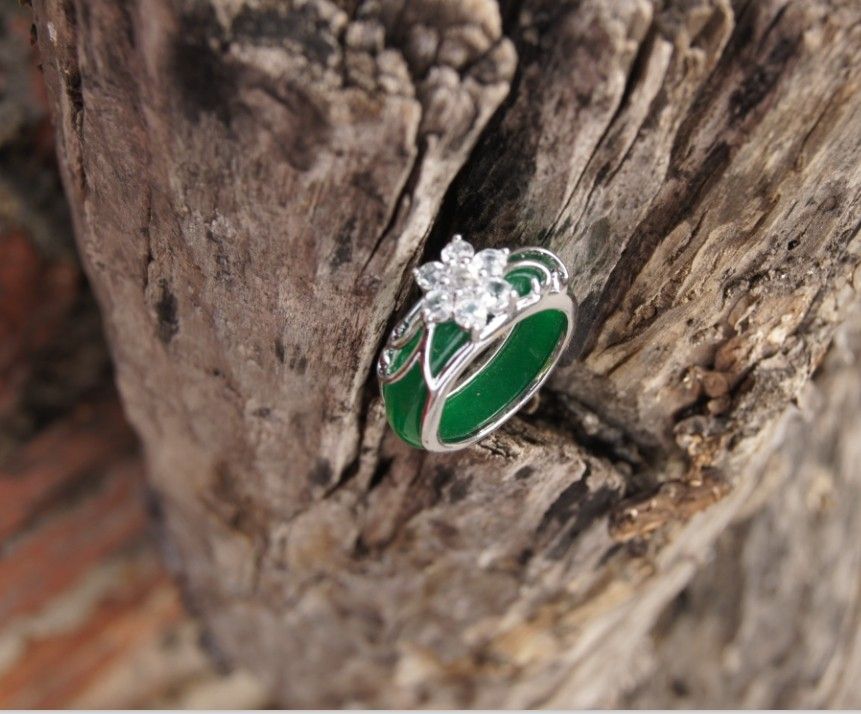 

Hand-made old alloy (plum blossom) lucky inlaid jade ring. Green jade ring surface.