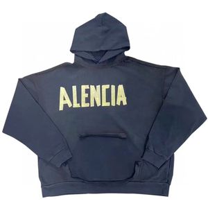 Sudadera con capucha con estampado de logotipo de cinta amarilla de otoño e invierno para parejas suéter lavado desgastado con letras sueltas