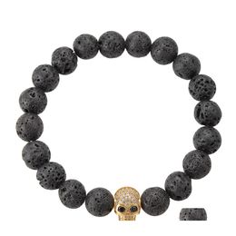 Hebras de cuentas Pulsera de cadena con cuentas de roca de lava de alta calidad Piedra de energía natural negra con brazalete de dije de esqueleto Skl dorado para mujeres Otmug