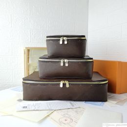 Caja de almacenamiento de flores marrones Cajas de joyería de viaje de cuero genuino Nuevos diseñadores Caja de almacenamiento de viaje Equipaje Cajas de baúl de moda Maletas Bolsas caja de bolsa de cosméticos