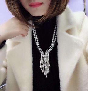 Chaînes pendentif en forme de corne Style littéraire ethnique exagéré Double couche collier de perles femme luxe haute joaillerie