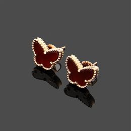 Diseñador de encanto flor de cuatro hojas oro de 18 quilates Ojo de tigre piedra letras VC mini aretes de mariposa mini conchas de colores lujo j301f