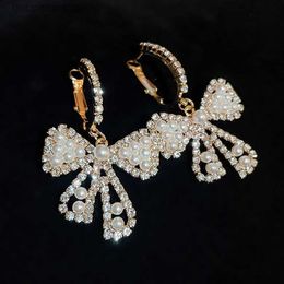 Charme incrusté strass arc perle boucles d'oreilles pour femmes français lumière luxe haut sens boucles d'oreilles personnalité Bowknot bijoux cadeau Y240328