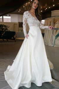 Goedkope lange trouwjurk met illusie lange mouwen kant kijken door top rok met zakken ontwerper een lijn bruids jurk bruidsjurken