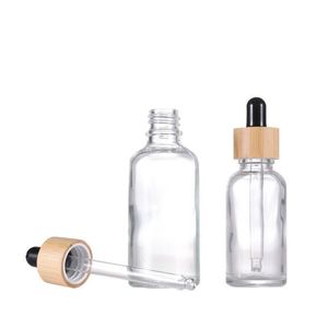 Bouteille à huile essentielle en verre essentiel avec couvercles en bambou Pipette de pipette d'emballage cosmétique transparente Stock Daijx