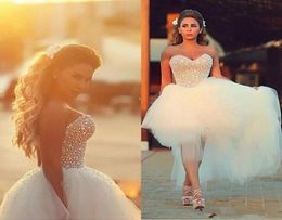 Corset Top Vestidos de novia 2019 Perlas con cuentas alto bajo Tul Verano Playa País Vestidos de novia Arabia Saudita Lujo Modest6328875