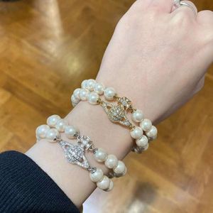 Dafu Bijoux de haute qualitéWestern Empress Dowager Pearl Bracelet Femme Polyvalent Unique Double Couche Plein Diamant Planète Boucle Magnétique Bracelet Lumière De Luxe